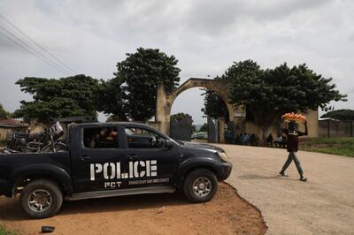 A police truck is stationed outside the University of Abuja where gunmen kidnapped a number of people. AFP