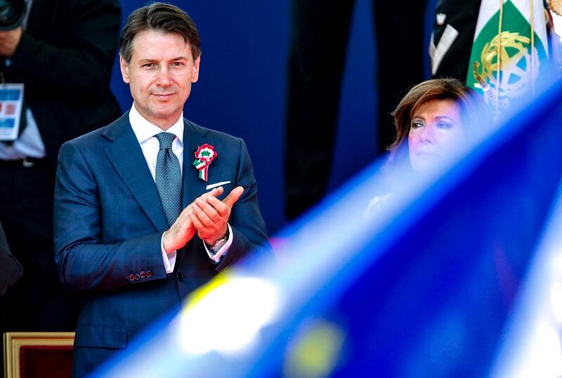 Italian Premier Giuseppe Conte, left, flanked by Senate president Maria Elisabetta Alberti Casellati, attends the celebrations for Italy's Republic Day, in Rome Saturday, June 2, 2018. At an oath-taking ceremony in the presidential palace atop Quirinal Hill, the new premier, political novice Giuseppe Conte, and his 18 Cabinet ministers pledged their loyalty to the Italian republic and to the nation's post-war constitution in front of President Sergio Mattarella. (Giuseppe Lami/ANSA via AP)