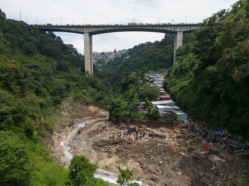 The Naranjo River moves through the "Dios es fiel," or "God is Loyal" shanty on the outskirts of Guatemala City. AP