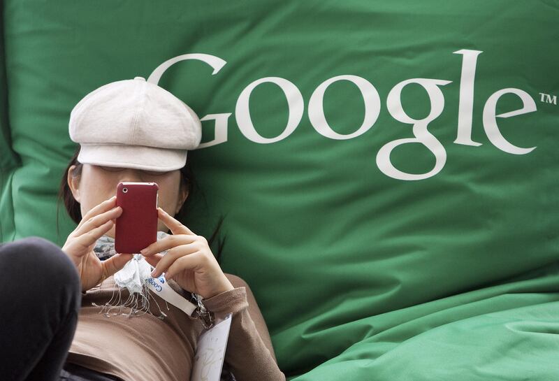 Nao Tanaka of Kyocera takes a break to send a text with a mobile device at the Google I/O conference in San Francisco, California, U.S., on Wednesday, May 11, 2011. Google Inc., the world's largest Internet-search company, is making a bigger push into entertainment services, adding music storage and movie-rental features to its Android software for phones and tablets. Photographer: David Paul Morris/Bloomberg *** Local Caption *** Nao Tanaka