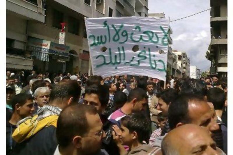 Syrian anti-government protesters rally in Banias last month. A reader condemns Damascus for its violent crackdown on peaceful demonstrations. AFP