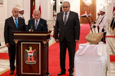 Iraqi President Abdul Latif Rashid, centre, flanked by Culture Minister Ahmed Fakak Al Badrani, left, and the director of the Iraqi Council of Antiquities and Heritage Laith Majid Hussein. AFP
