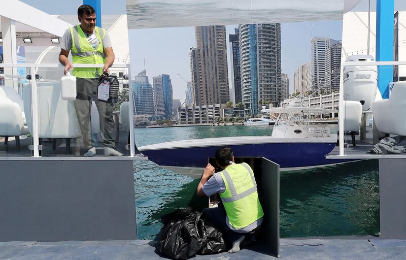 DUBAI , UNITED ARAB EMIRATES , February 26 – 2019 :- Workers giving final touches at the Dubai International Boat Show held in Dubai. ( Pawan Singh / The National ) For News/Instagram/Big Picture. Story by Nick Webster 