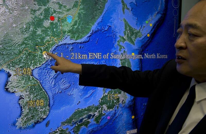 Kuo Kai-wen, director of Taiwan's Seismology Center, explains the locations from a monitor showing North Korea's first hydrogen bomb test site (AFP PHOTO / Sam Yeh)