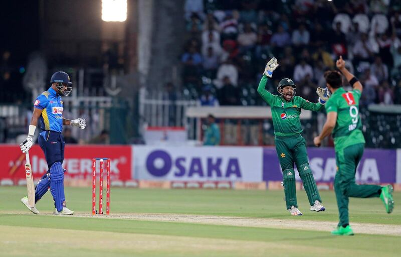 Pakistani captain and wicketkeeper Sarfaraz Ahmed, center, celebrates the dismissal of Sri Lankan batsman Danushka Gunathilaka during the second T20 in Lahore. AP