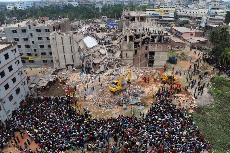 Bangladeshi volunteers and rescue workers are pictured at the scene after the Rana Plaza complex collapsed in Savar, on the outskirts of Dhaka on April 25, 2013. Munir uz Zaman / AFP Photo 