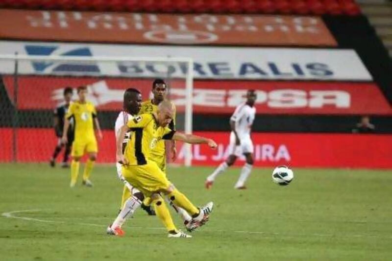 Mariano Donda, front, passes the ball under pressure from Al Jazira's Ibrahim Diaky as Al Wasl won 3-2 in Abu Dhabi last night. Pawan Singh / The National