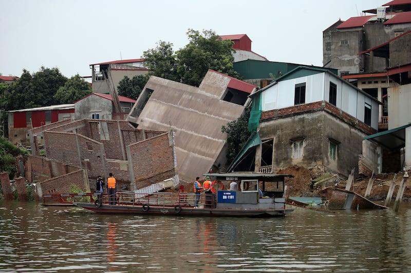 The scene in Bac Ninh province, Vietnam, after six houses collapsed into the Cau river. About 27 people were evacauted to safety, according to local authorities. EPA