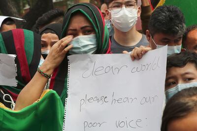 An Afghan woman weeps as she holds a poster during a rally outside the building that houses UNHCR representative office in Jakarta, Indonesia, Tuesday, Aug.  24, 2021.  Hundreds of Afghan refugees living in Indonesia, mostly members of the Hazara ethnic minority, held the rally on Tuesday decrying the Taliban's takeover of their country and calling for resettlement in third countries.  (AP Photo / Tatan Syuflana)