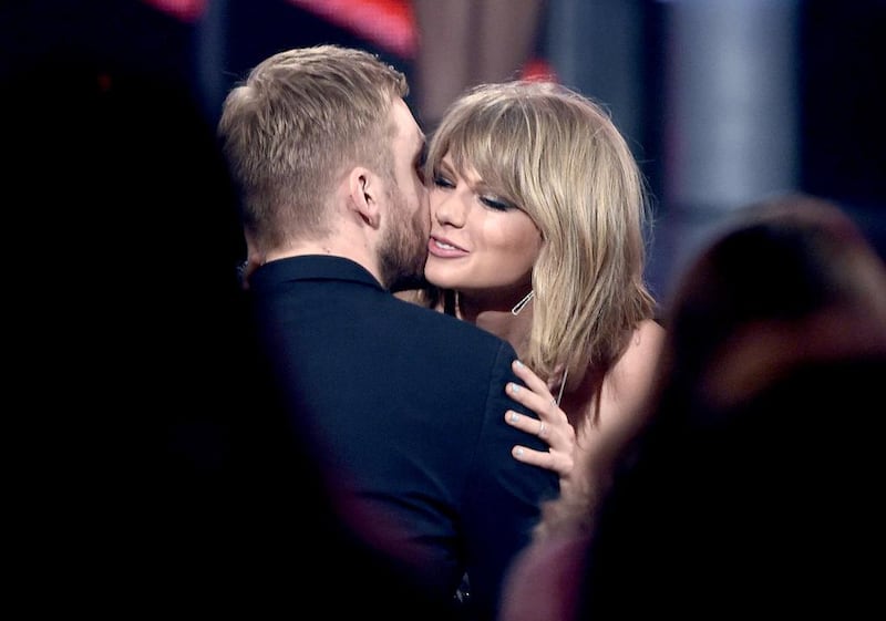 Taylor Swift, right, hugs Calvin Harris after winning the award for top billboard 200 album for 1989. AP
