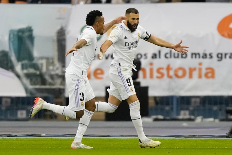 Eder Militao and Benzema celebrate. AP