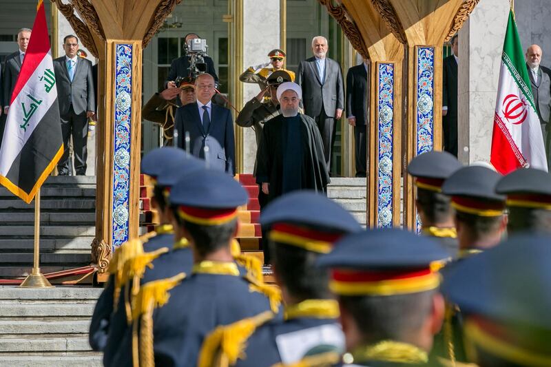 Iraq's President Barham Salih stands with Iran's President Hassan Rouhani during a reception in Tehran. Reuters