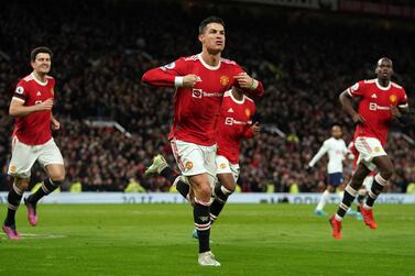 Manchester United's Cristiano Ronaldo, center, celebrates after scoring his third goal during the English Premier League soccer match between Manchester United and Tottenham Hotspur, at the Old Trafford stadium in Manchester, England, Saturday, March 12, 2022.  (Martin Rickett / PA via AP)