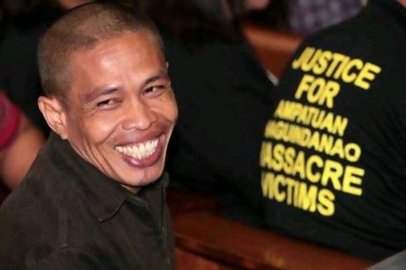 Witness Lakmudin Saliao smiles before testifying in the trial for the November 2009 massacre of 57 people in Maguindanao province in the southern Philippines.