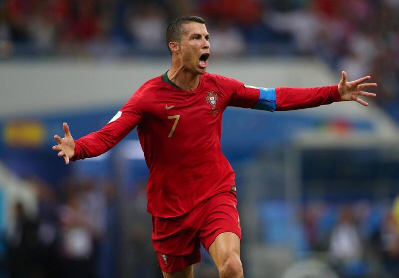 Portugal's Cristian Ronaldo wheels away in celebration after his free kick found the back of the net, giving his team a 3-3 draw and himself a World Cup hattrick. Hannah McKay / Reuters