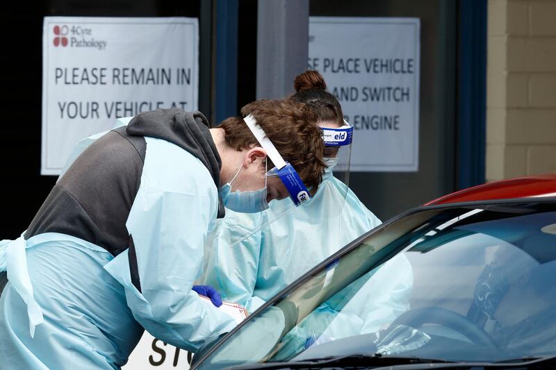 Medical professionals perform Covid-19 testing at a drive-through clinic in Ballarat, Australia. Getty Images