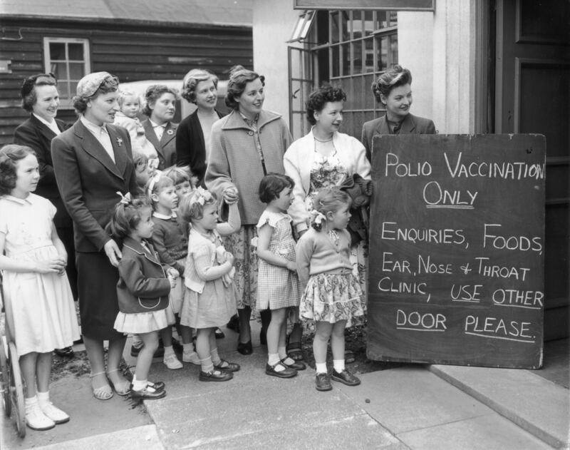 A group of mothers with their children wait outside Middlesex County Council Clinic for the first polio vaccinations in May 1956. All photos: Getty Images