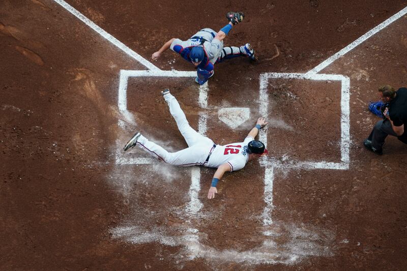 Atlanta Braves batter Sean Murphy (12) scores a home run as he gets past Los Angeles Dodgers catcher Will Smith during the first inning of a baseball game in Atlanta. AP