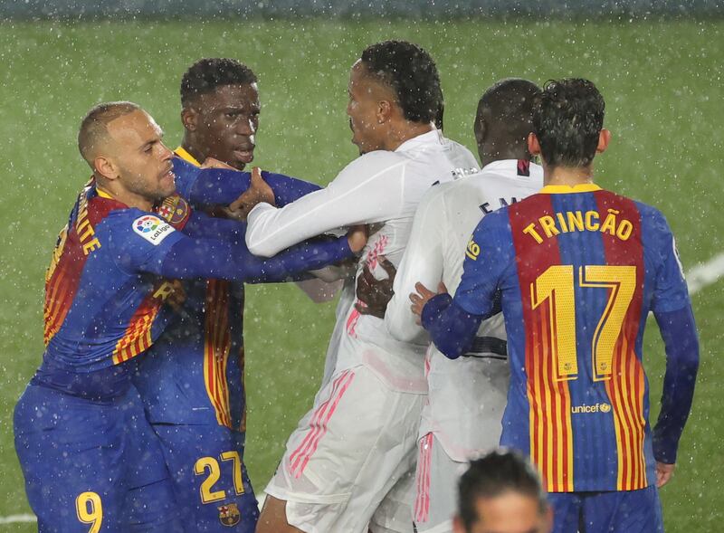 Players scuffle during the Clasico. EPA