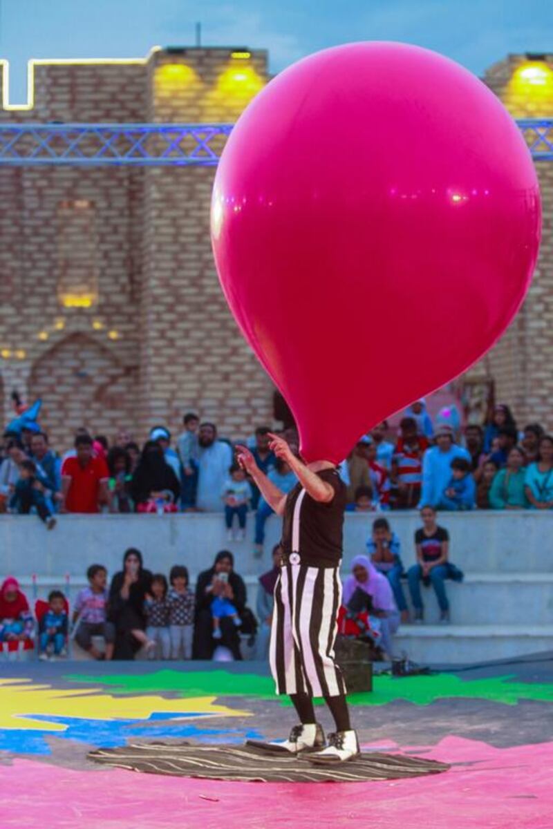 <a href="http://www.thenational.ae/business/economy/sme-profile-dolphin-creatives-street-artists-perform-to-standing-ovation#2">The Dolphin Creative street artist</a> Otto Bas Sotto from Italy does some balloon tricks with the help of a volunteer from the audience. The company brings street performers from across the globe to jobs in the UAE. Victor Besa for The National