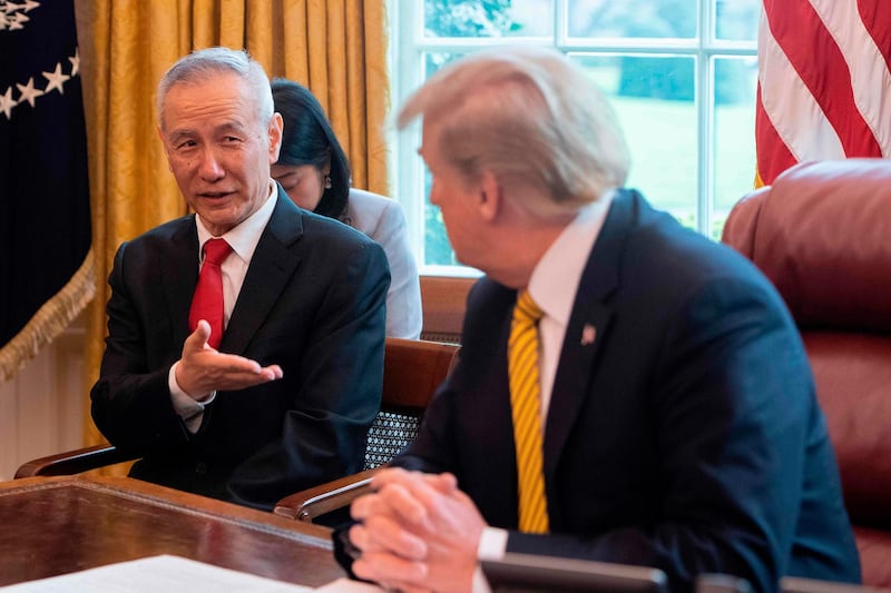 (FILES) In this file photo China's Vice Premier Liu He (L) speaks with US President Donald Trump during a trade meeting in the Oval Office at the White House in Washington, DC, on April 4, 2019. Chinese Vice Premier Liu He will travel to Washington on January 13 to sign the "Phase One" trade deal with the United States, the commerce ministry said Thursday.
Liu, China's top negotiator in the trade war, will be in the US capital from Monday to Wednesday, the ministry said, a week after President Donald Trump said the agreement would be signed on January 15.
 / AFP / Jim WATSON
