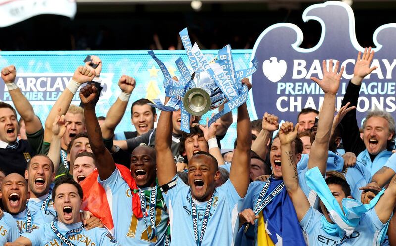 MANCHESTER, ENGLAND - MAY 13:  Vincent Kompany the captain of Manchester City lifts the trophy following the Barclays Premier League match between Manchester City and Queens Park Rangers at the Etihad Stadium on May 13, 2012 in Manchester, England.  (Photo by Alex Livesey/Getty Images)