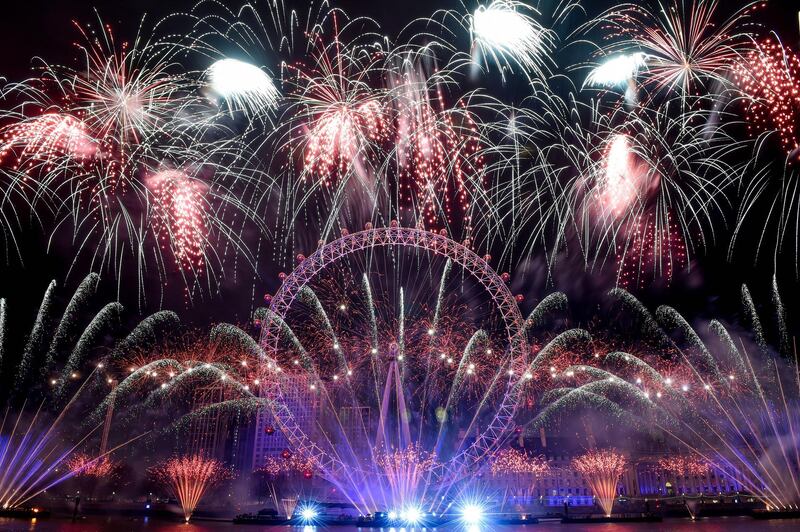 Fireworks explode over the iconic London Eye marking the beginning of the New Year in central London.  EPA