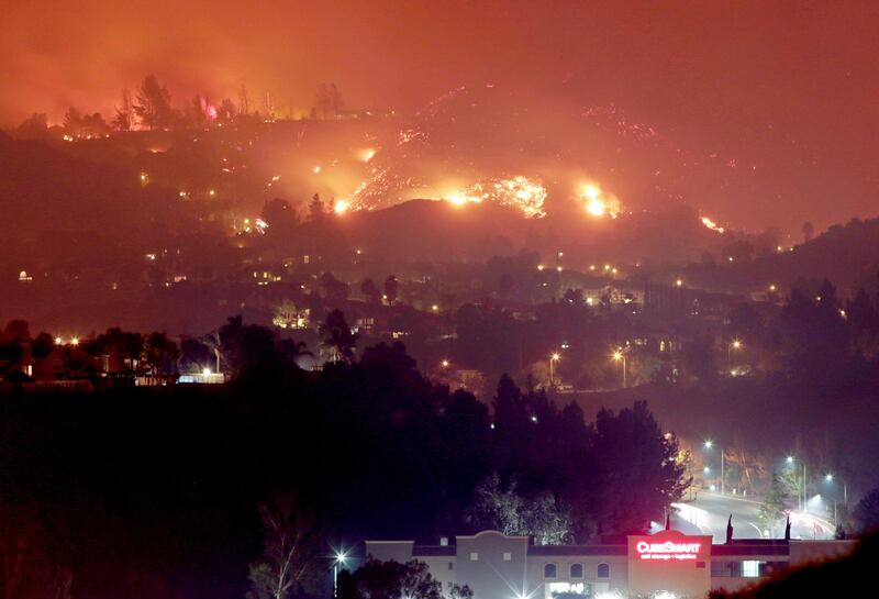 The Canyon Fire burns hillsides above houses in Corona, California. Kyle Grillot / Reuters