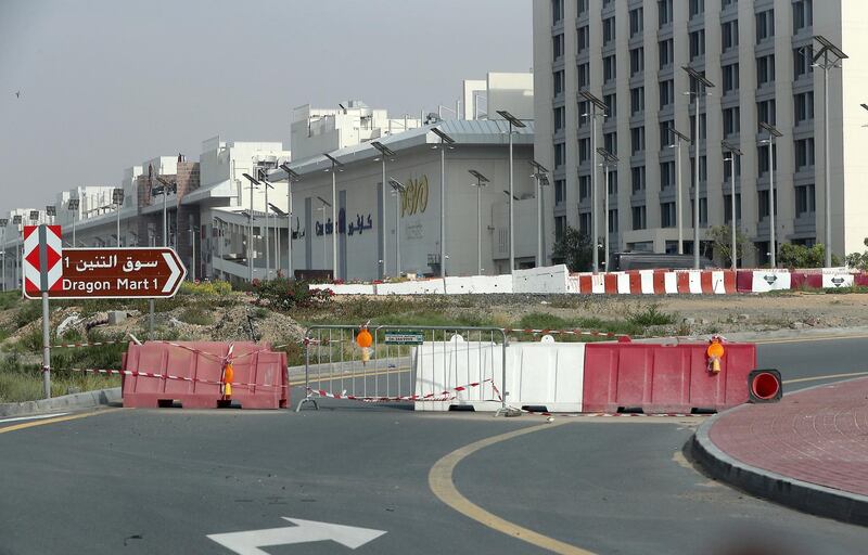 DUBAI, UNITED ARAB EMIRATES , April 18– 2020 :- Entrance to Dragon Mart 1 is closed by Dubai Police. Only two entrance are open for vehicles coming from Al Awir road before the Dragon Mart 1 and Manama Street to International City in Dubai.  Dubai is conducting 24 hours sterilisation programme across all areas and communities in the Emirate and told residents to stay at home. UAE government told residents to wear face mask and gloves all the times outside the home whether they are showing symptoms of Covid-19 or not.  (Pawan Singh / The National) For News/Online