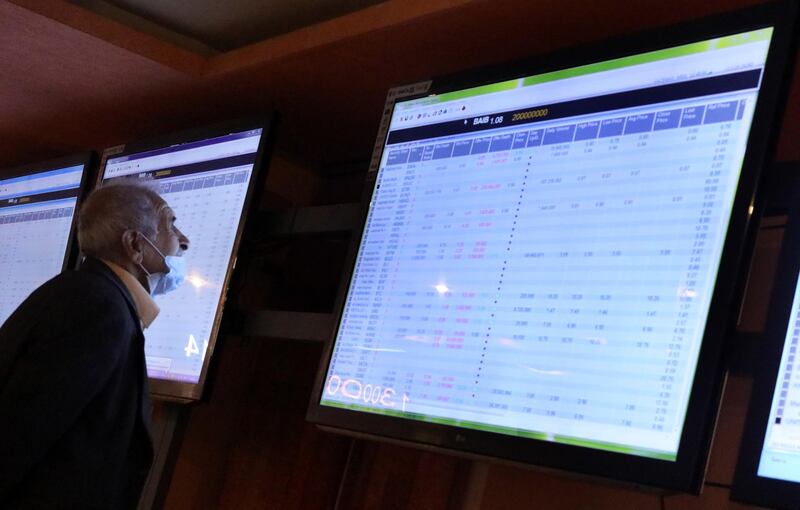 An Iraqi Investor looks at an electronic board showing shares information at the Iraqi Stock Exchange in Baghdad. EPA