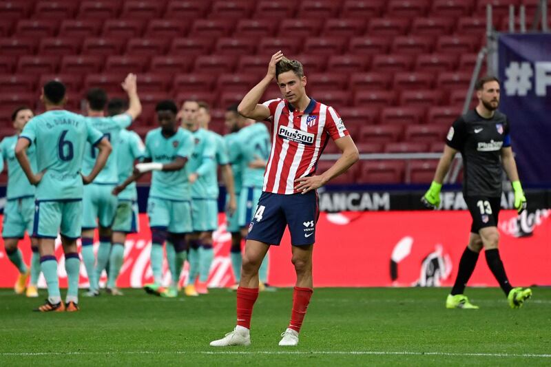 Atletico Madrid's Spanish midfielder Marcos Llorente reacts to Levante's second goal during the Spanish league football match between Club Atletico de Madrid and Levante UD at the Wanda Metropolitano stadium in Madrid on February 20, 2021. / AFP / JAVIER SORIANO
