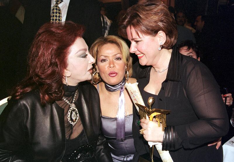 Nabila Obeid (left) and belly dancer Lucy (centre) congratulate Dalal Abdel Aziz, who won best actress award for her role in 'Asrar al-Banat', at the Egyptian Oscar Film Festival on March 8, 2002 in Cairo.