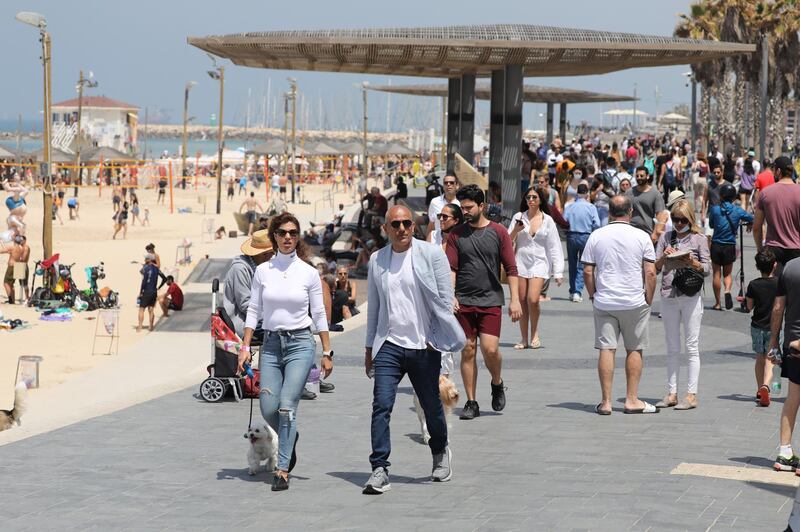 People without face masks enjoy the weather on the beach of Tel Aviv. EPA