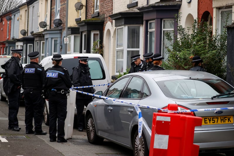 Police officers gather outside a house in the Kensington area in Liverpool where counterterrorism officers arrested three men. Reuters