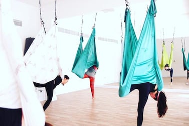 Aerial, swing or hammock yoga is offered at many yoga spots in the UAE, including The Studio in Abu Dhabi, pictured. Photo: Instagram / TheStudioUAE