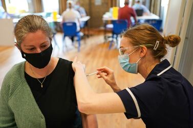 Sarah Robinson-Gay receives the Pfizer-BioNTech Covid-19 vaccine at the Hexham Mart vaccination centre, northern England. Getty Images