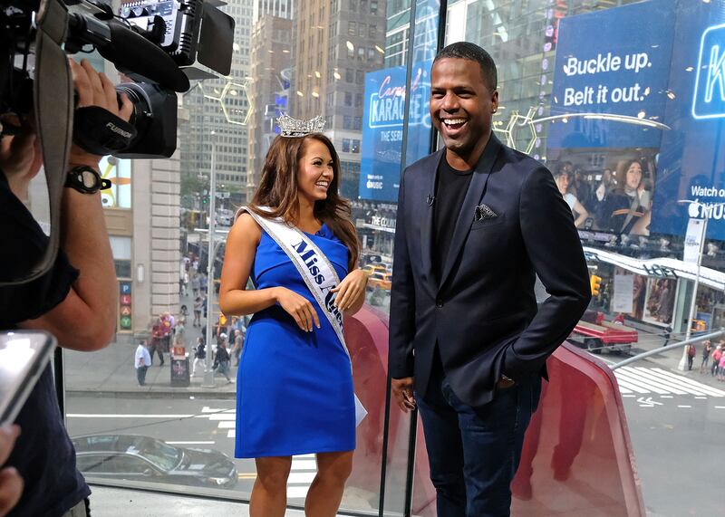 Ms Mund on her Miss America press tour with then 'Extra' host AJ Calloway. Getty / AFP 