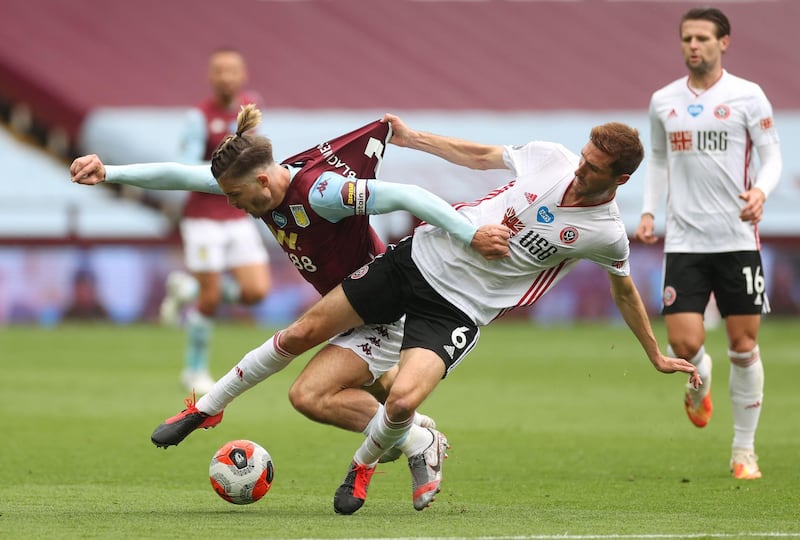 Aston Villa's Jack Grealish, left, battles for the ball with Chris Basham of Sheffield United as the Premier League returned to action on Wednesday, June 17. The match at Villa Park finished 0-0. AFP