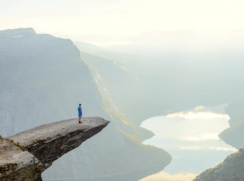 Hiker standing on Trolltunga at Odda, Hordaland county, Norway