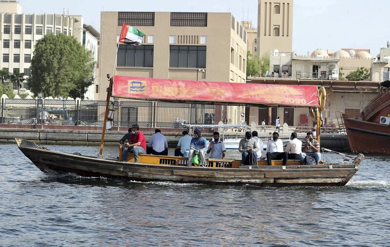 DUBAI, UNITED ARAB EMIRATES , July 2– 2020 :- People wearing protective face mask on the Abra in Dubai Creek in Dubai. (Pawan Singh / The National) For News/Standalone/Online/Stock
