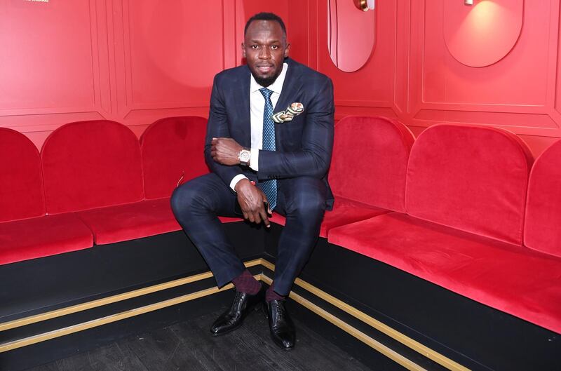 Usain Bolt poses for photos at the Birdcage on Melbourne Cup Day. EPA