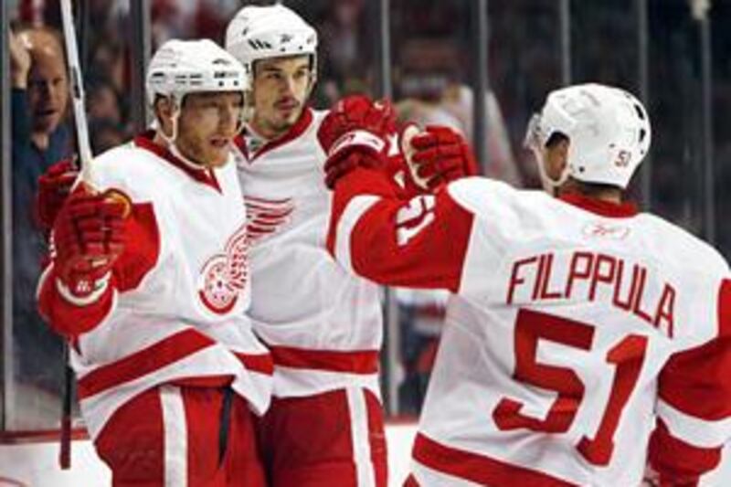Detroit Red Wings' Marian Hossa, left, celebrates one of his goals with Jonathan Ericsson and Valtteri Filppula.