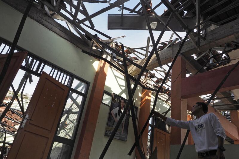 A man inspects the damage at a school building after an earthquake in Tasikmalaya, West Java, Indonesia. Erwin Widiagiri / AP Photo