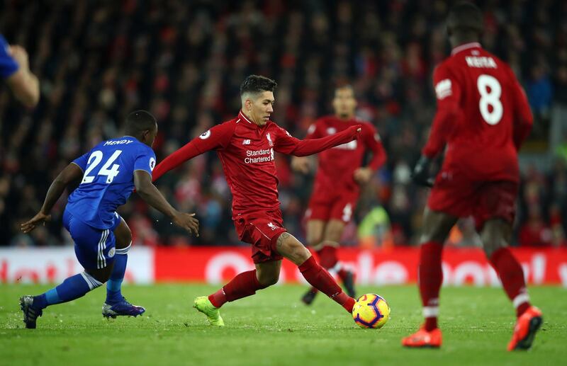 LIVERPOOL, ENGLAND - JANUARY 30:  Roberto Firmino of Liverpool evades Nampalys Mendy of Leicester City during the Premier League match between Liverpool FC and Leicester City at Anfield on January 30, 2019 in Liverpool, United Kingdom.  (Photo by Clive Brunskill/Getty Images)