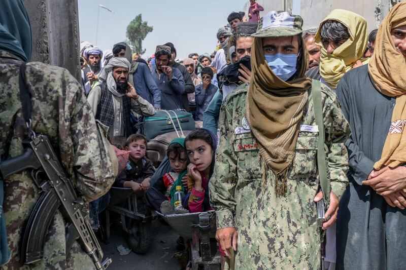 Taliban members patrol at the Spin Boldak border crossing as people try to enter Pakistan. Photo: AFP