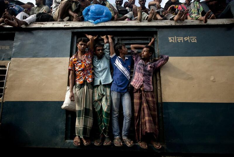 People travel in a crowded train in Dhaka, Bangladesh.