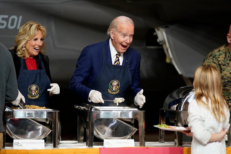 President Joe Biden and first lady Jill Biden react as they serve dinner at Marine Corps Air Station Cherry Point in Havelock, N. C. , Monday, Nov.  21, 2022, at a Thanksgiving dinner with members of the military and their families.  (AP Photo / Patrick Semansky)