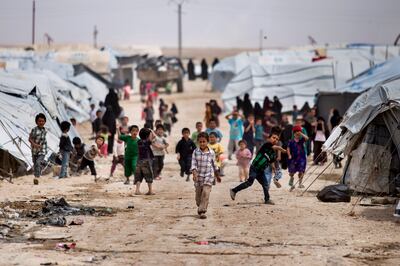 Children gather outside their tents in Al Hol camp. AP