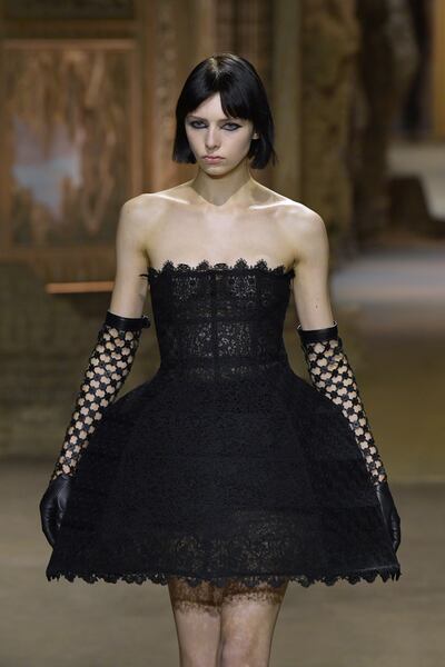 An all-lace, crinoline mini dress, with woven gloves at Dior spring/summer 2023. Getty Images