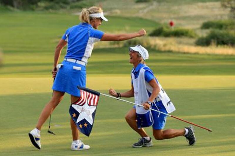 Giulia Sergas celebrates with Nadia Bortoluzzi, her caddie, on the 18th green during the final day singles matches in the Solheim Cup. David Cannon / Getty Images / AFP
